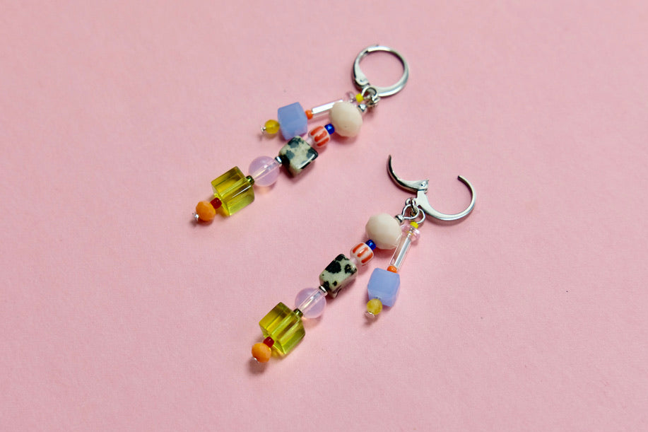 Colorful beaded huggies on a pink background