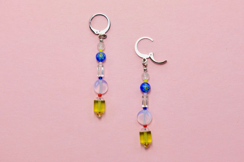 Pair of beaded earrings on a pink background