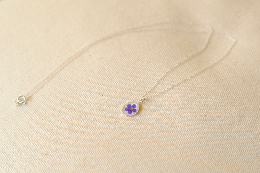 silver necklace with pressed flower
