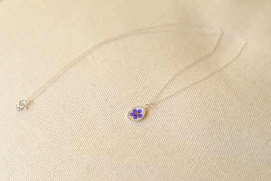 silver necklace with pressed flower