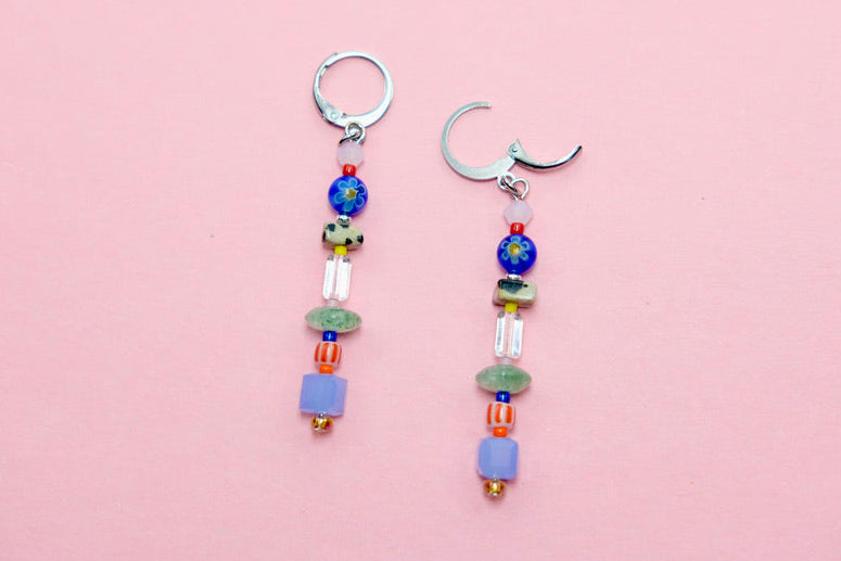 Pair of beaded earrings on a pink background