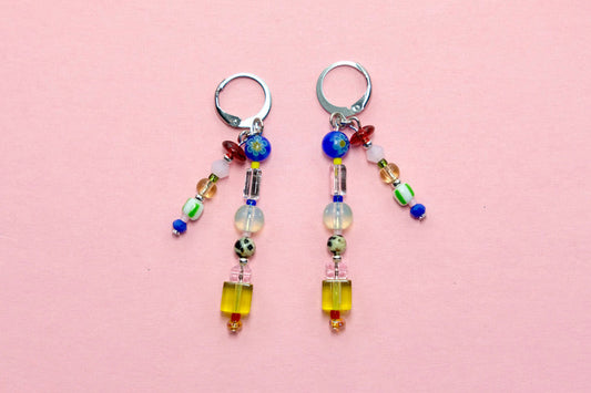 Pair of beaded earrings on a pink background